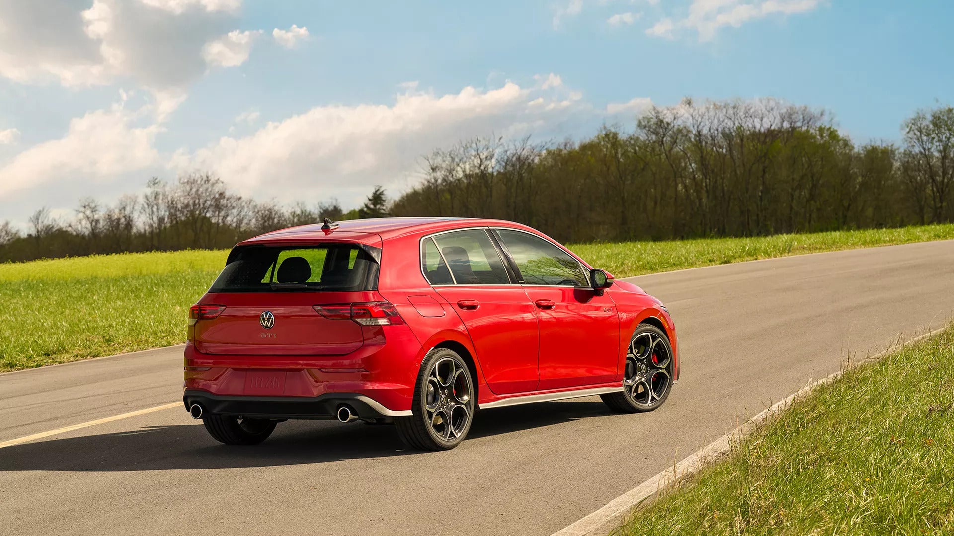 a blue Volkswagen Golf GTI parked in a parking lot
