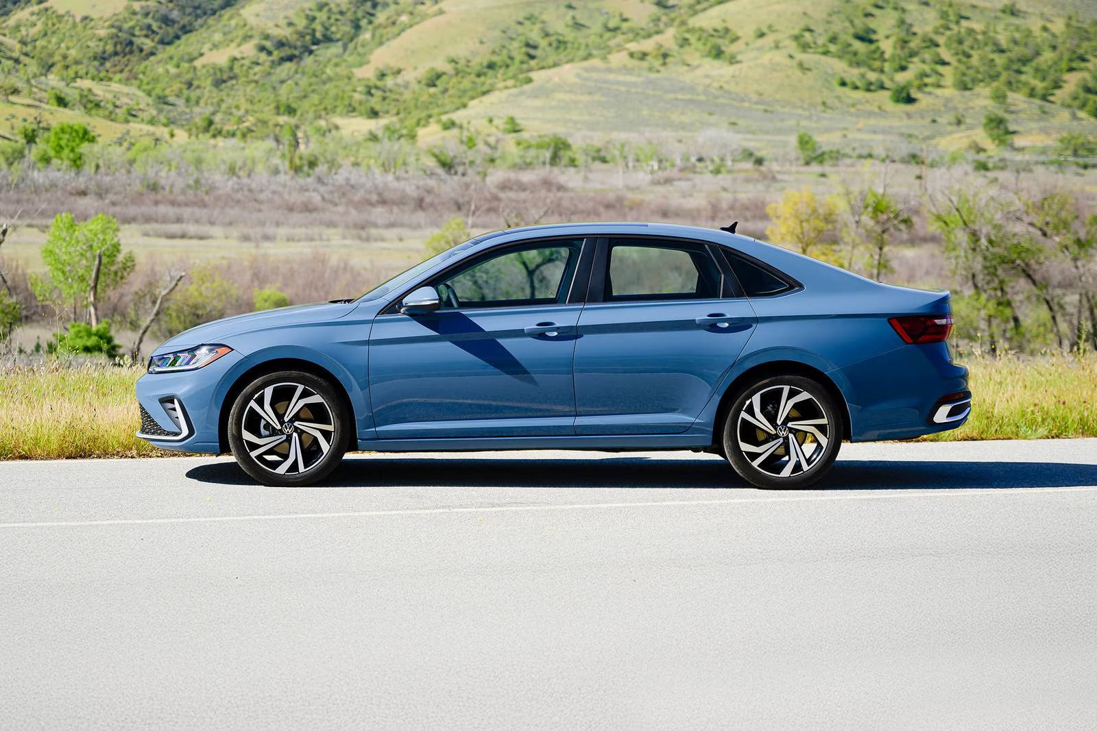 A blue jetta sitting parked.